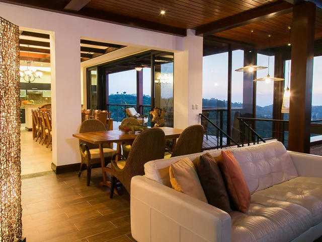 Living area at Villa Celaje opening onto the balcony at dusk