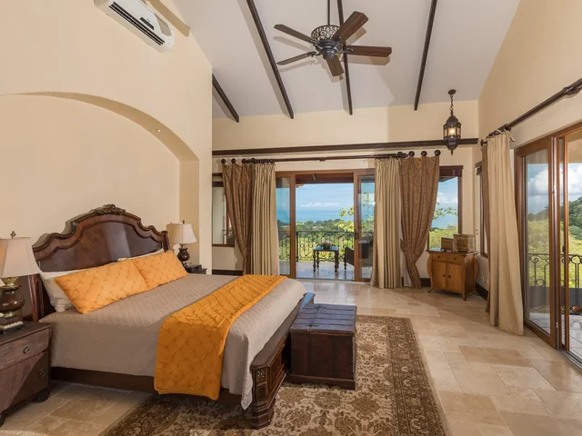 Bedroom suite at Villa Marbella with ocean-view balcony
